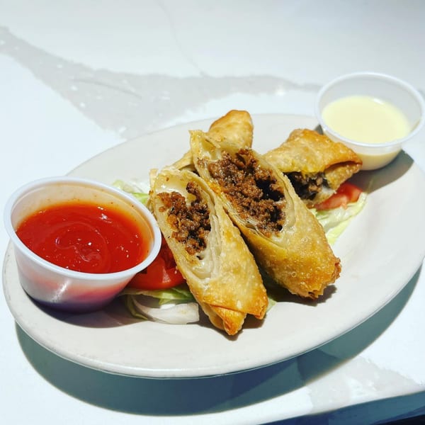 B-UNOS' crispy egg rolls filled with seasoned ground beef, served with ketchup and a creamy dipping sauce.