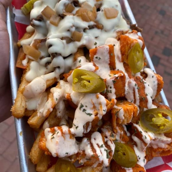 B-UNOS's loaded fries with cheese sauce, meat, buffalo chicken, and jalapeños.